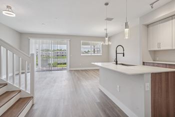 The living room and kitchen of a new home with an open floor plan